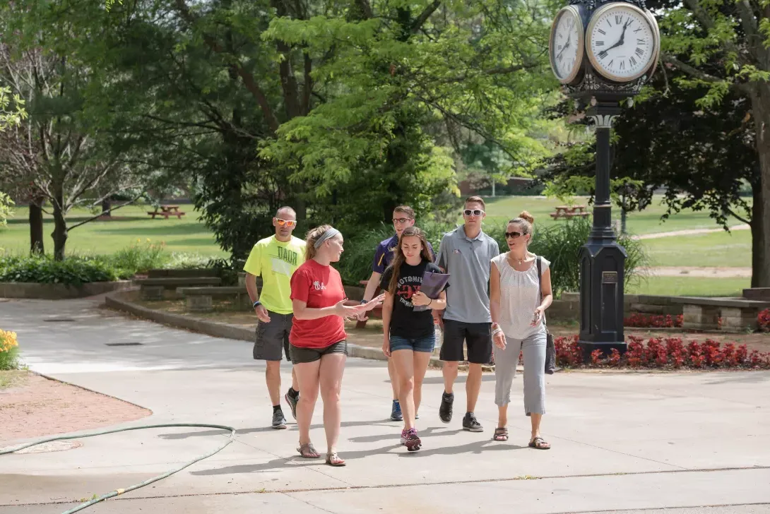 Admissions tour guide showing prospective students and parents the campus